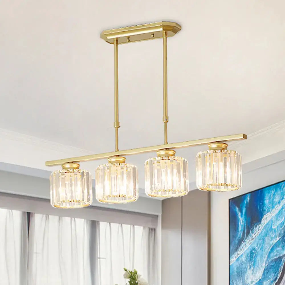 Gold-toned modern brass rectangular crystal ceiling pendant light with four faceted glass shades and adjustable chain cord length for dining room