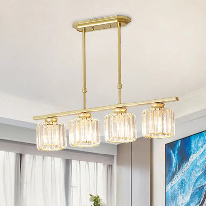 Gold-toned modern brass rectangular crystal ceiling pendant light with four faceted glass shades and adjustable chain cord length for dining room