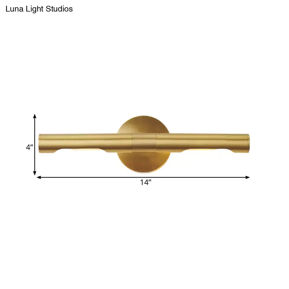 Modern brass tube vanity light featuring a sleek cylindrical bar and circular backplate wall sconce