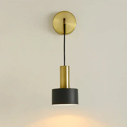 Modern brass wall lamp featuring a gold-toned cylindrical sconce with a matte black shade for minimalist decorbites brass wall lamp design