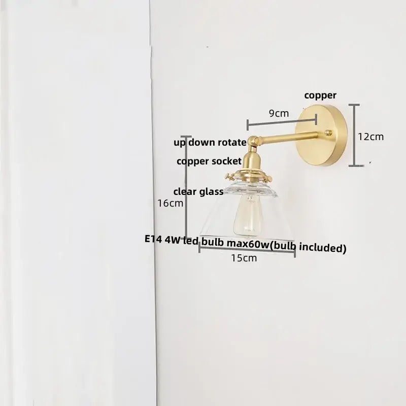 A modern brass wall lamp with clear glass shade and brass-finished copper for bedroom reading light decorbites clear glass