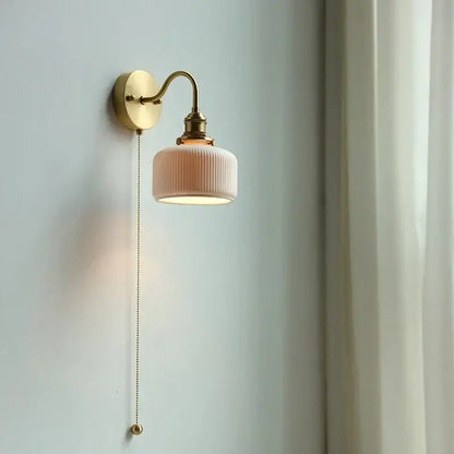 Modern brass wall lamp with ribbed soft pink ceramic shade and decorbites copper arm for bedroom reading light decor