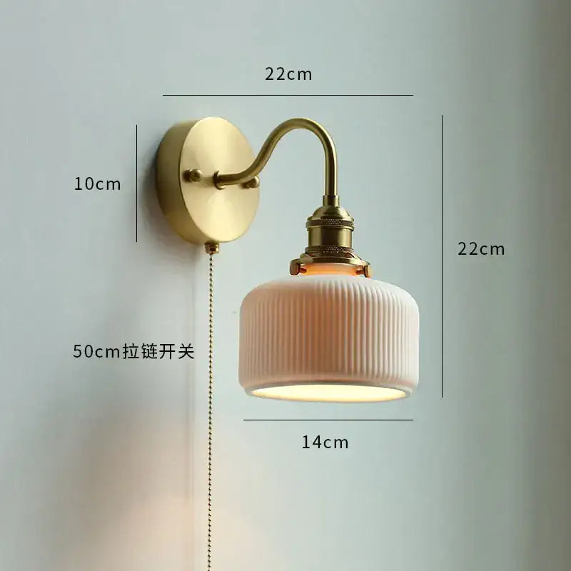 Modern brass wall lamp with cream ribbed ceramic shade and brass arm suitable as a bedroom reading light decorbites copper arm wall