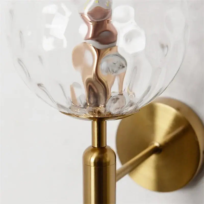 Modern brass wall lights with gold-toned metal and a textured clear glass decorbites glass ball for living room decor