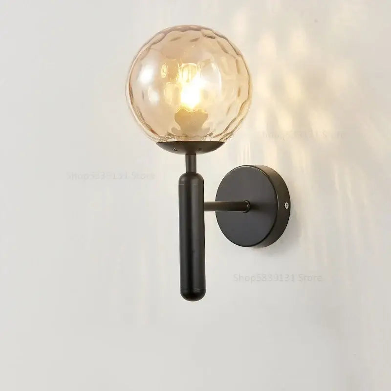 A modern black metal wall light with textured amber glass globe for living room decorbites glass ball wall lamps