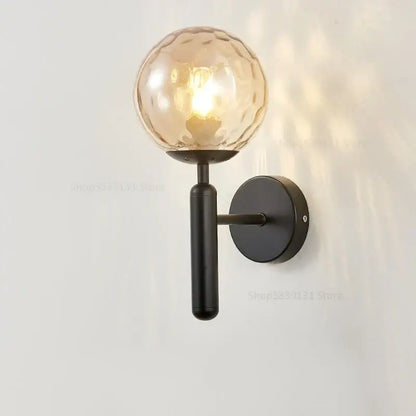 A modern black metal wall light with textured amber glass globe for living room decorbites glass ball wall lamps