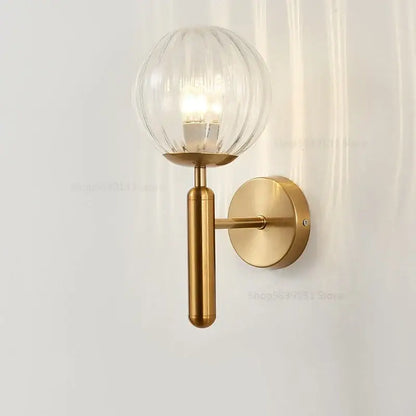 Modern brass wall light with ribbed clear glass globe and cylindrical stem for living room decorbites glass ball wall lamps