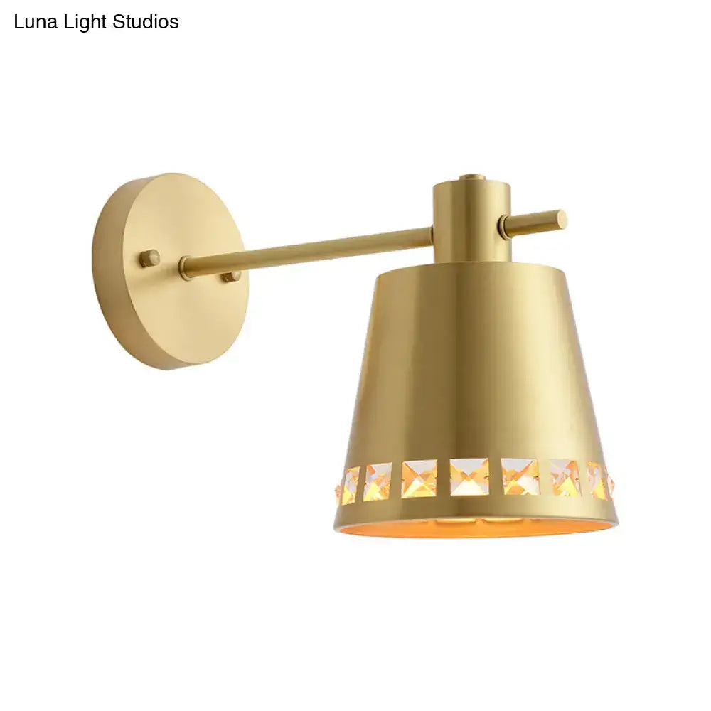 Modern brass wall mount light with gold finish and clear crystal accent in conical shade for direct wired electric use
