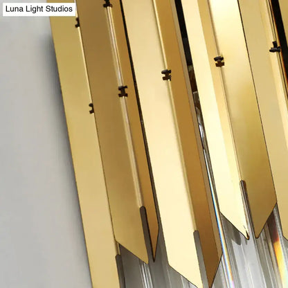 Modern brass wall mount light with clear crystal prism features gold-toned metallic panels and black hardware accents