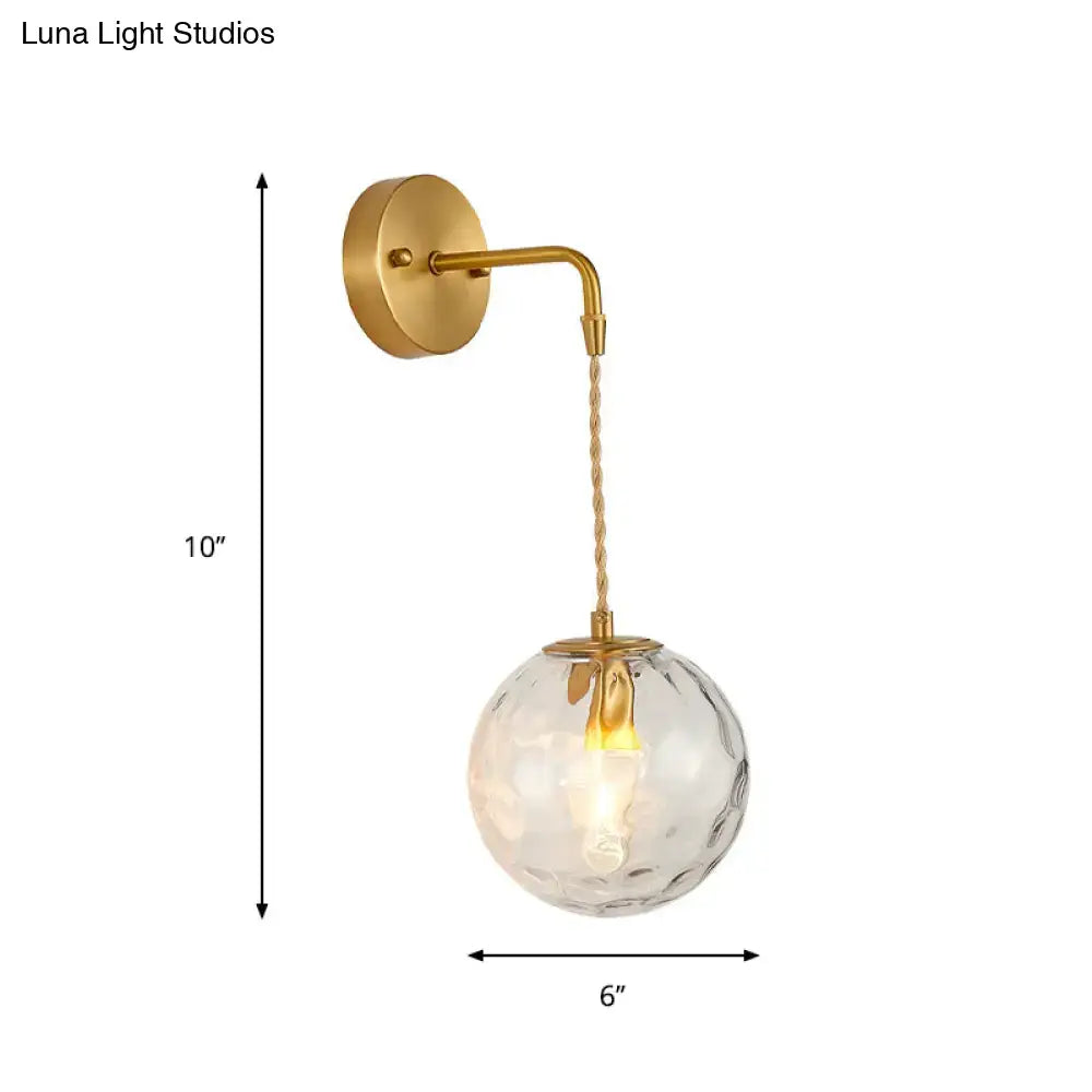 Modern brass wall sconce with gold finish and textured clear water glass shade for bedroom lighting with e12 e14 bulbs