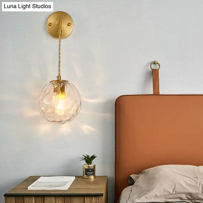Modern brass wall sconce with textured clear glass shade and braided cord compatible with e12 e14 bulbs
