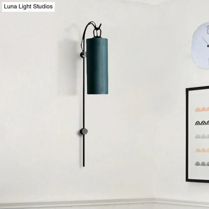 Dark teal cylindrical wall sconce with sleek black metal arm and decorative toggle for direct wired electric 220v-240v use