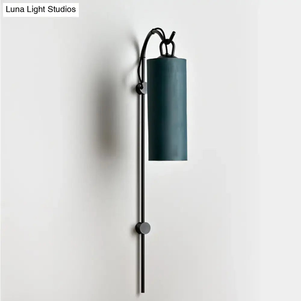Modern teal cylindrical wall sconce with black metal arm and adjustable height direct wired electric 220v-240v