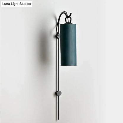 Modern teal cylindrical wall sconce with black metal arm and adjustable height direct wired electric 220v-240v