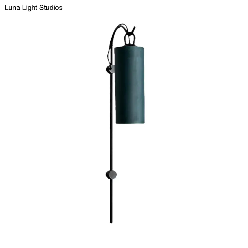 Dark teal cylindrical direct wired electric wall sconce with black metal arm and adjustable height for 220v-240v use
