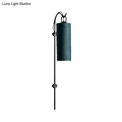 Dark teal cylindrical direct wired electric wall sconce with black metal arm and adjustable height for 220v-240v use