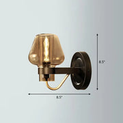 Modern bronze and brass smoke gray wall lamp with a bronze finish, smoked glass shade, and brass accent arm for porch lighting