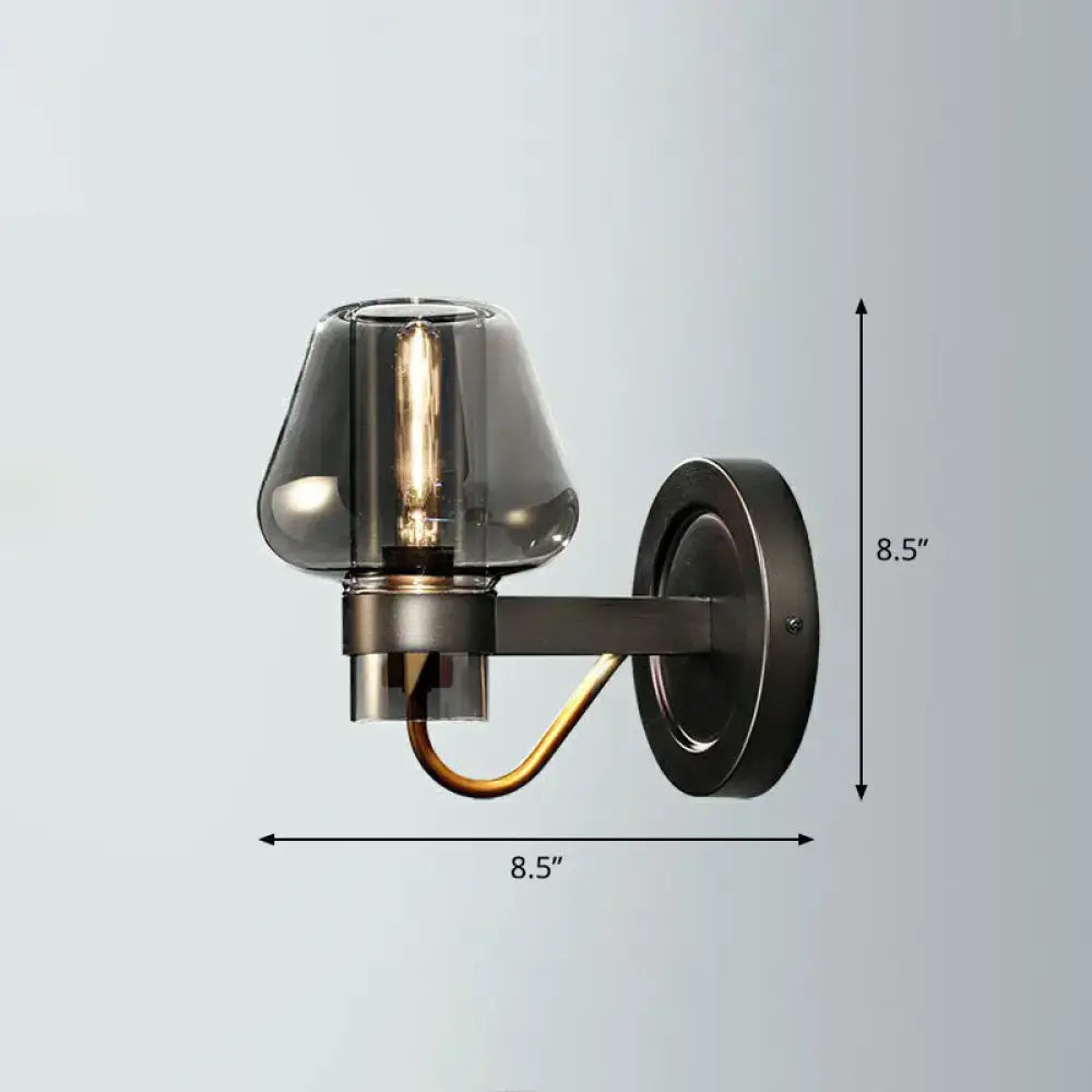 Modern bronze and brass smoke gray wall lamp with amber glass shade and curved accent arm for porch lighting