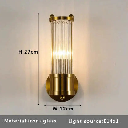 Gold-toned wall sconce with vertical glass rods and cylindrical iron base complementing modern ceiling fan light