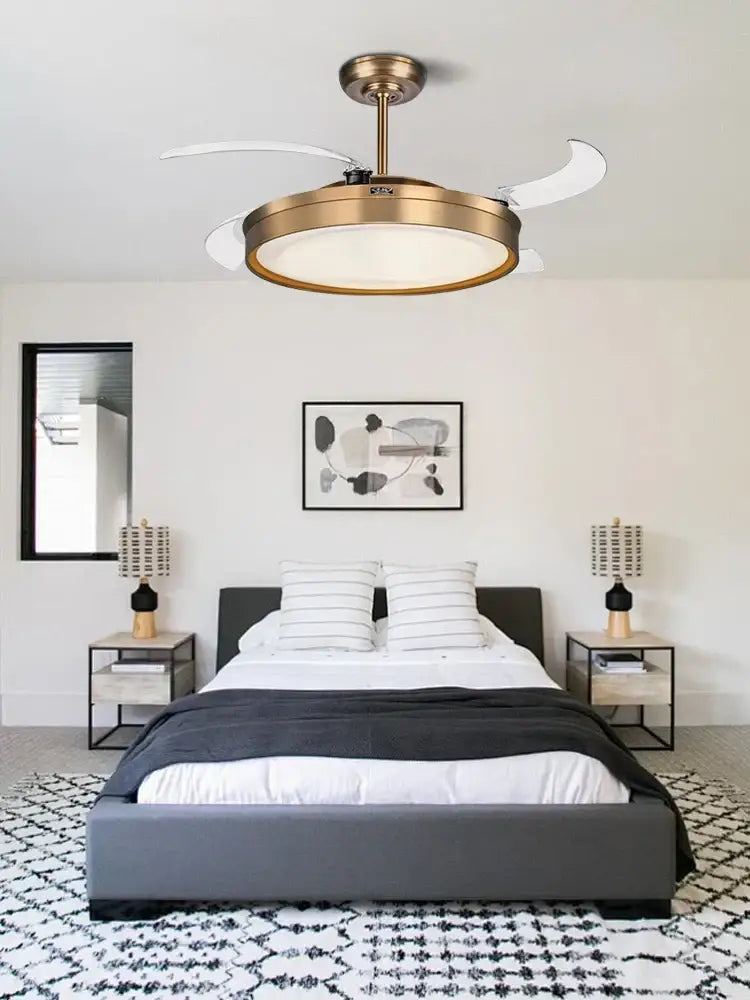 Brass-finished modern ceiling fan light with white translucent reversible blades and circular light fixture for living room