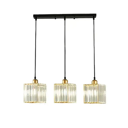 Modern bronze crystal trio pendant light with clear vertically ribbed glass shades and gold-toned metal accents for dining room decorbites crystal trio pendant