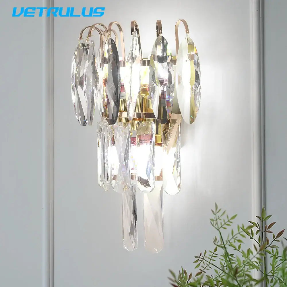A wall light with a gold-toned metal frame and clear crystal droplets decorbites crystal led for modern living room