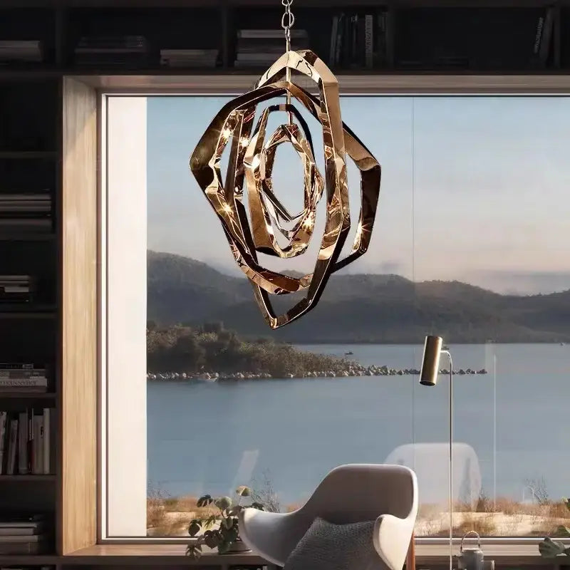 Modern bronze geometric art pendant chandelier with layered spiral design in polished gold metal for dining room decorbites pendant light