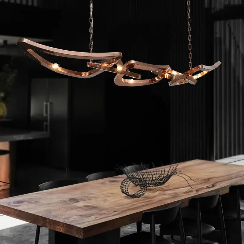 Modern bronze geometric art pendant chandelier with copper-toned intertwined curves and warm LED bulbs for dining room decorbites art pendant
