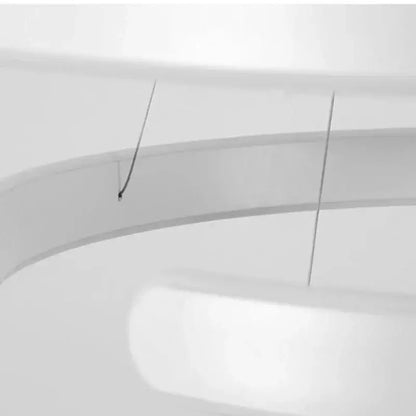 White curved toilet seat with black hinges shown alongside modern bronze geometric pendant light fixture for dining room