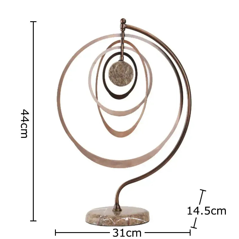 Modern bronze intertwined geometry sculpture with concentric rings and central disc on marble base desk decoration decorbites