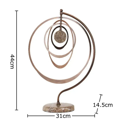 Modern bronze intertwined geometry sculpture with concentric rings and central disc on marble base desk decoration decorbites