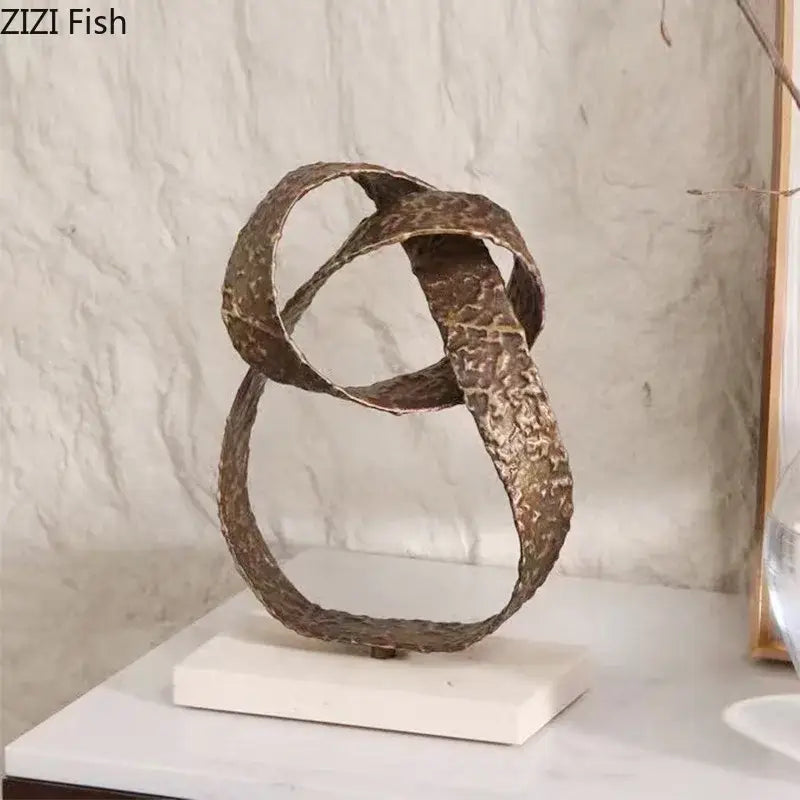 Modern bronze intertwined geometry sculpture in textured metal with a marble base for desk decoration by decorbites