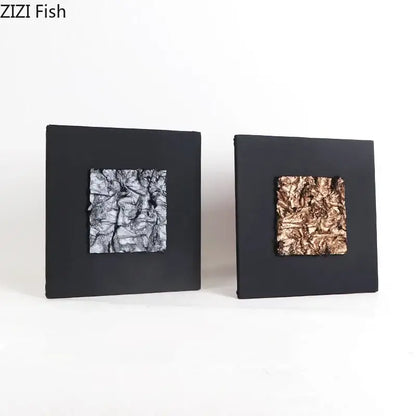 Two square black-framed wall art pieces with silver and copper crinkled foil centers from decorbites gilded fabric wall art collection