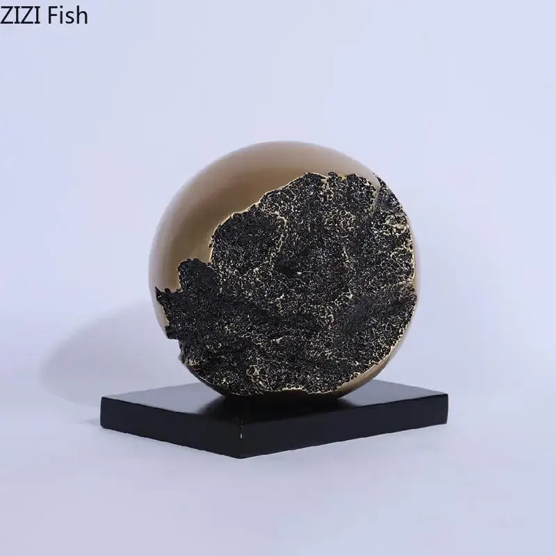 Modern bronze sphere sculpture desk ornament with smooth beige exterior and textured black interior for living room decor