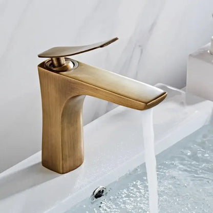 Modern bronze basin faucet with a sleek minimalist design and flat spout for bathroom sink use by decorbites