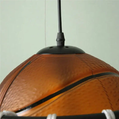 Modern brown basketball pendant light with textured orange surface and black seams ideal for kids room decorbites basketball pendant