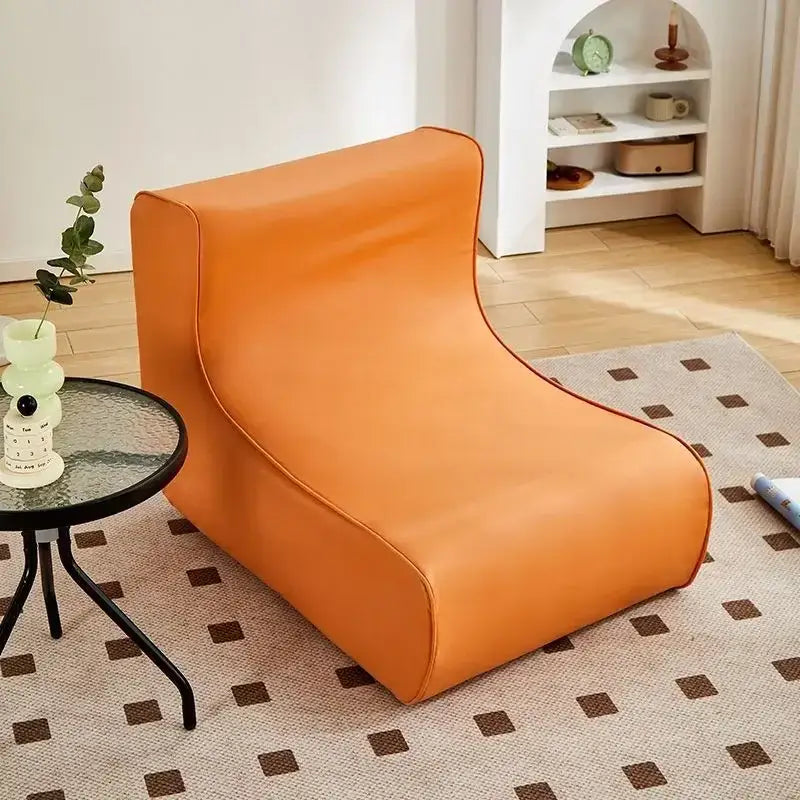 Modern brown and black faux leather cozy sofa chair with vibrant orange upholstered lounge chair and soft padded contours