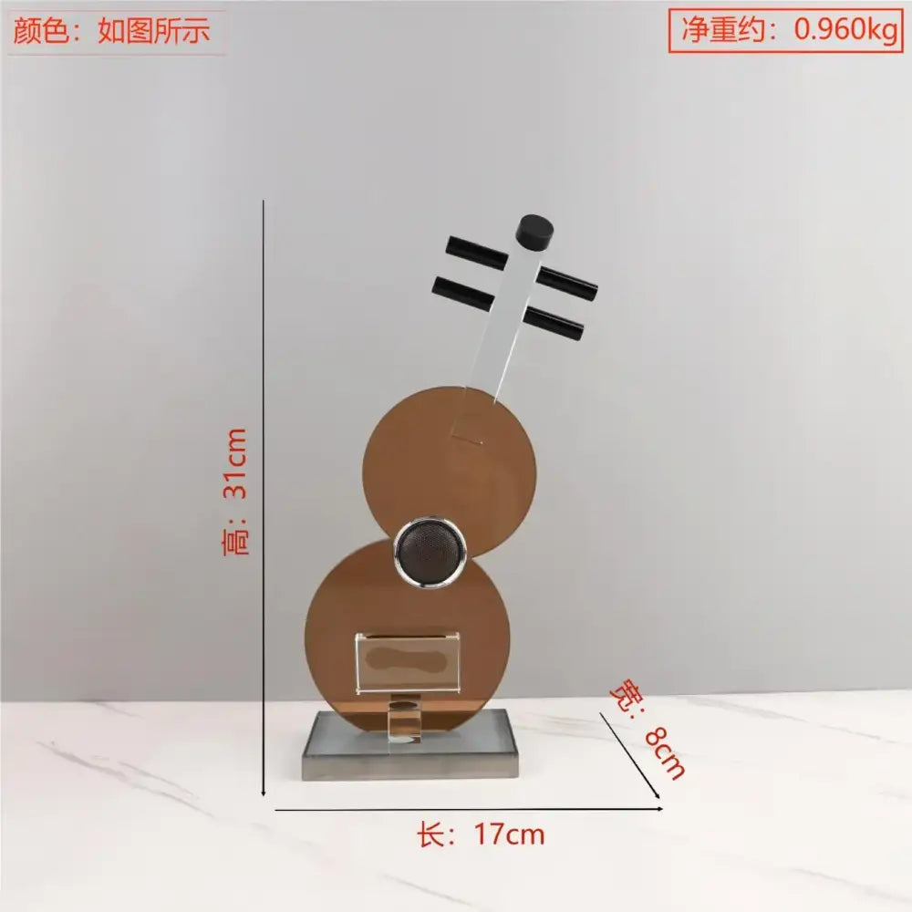 A sleek modern decorbites crystal guitar sculpture with polished bronze bodies and black neck accents for living room decor