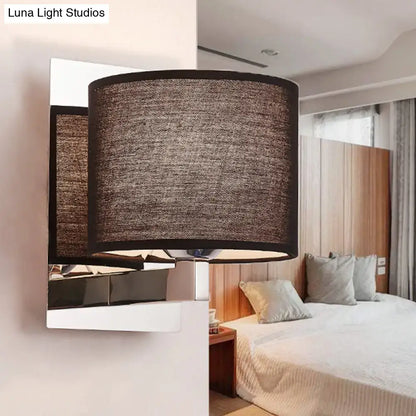 Modern brown fabric wall mount sconce with a cylindrical textured lampshade and sleek metallic base for bedroom lighting