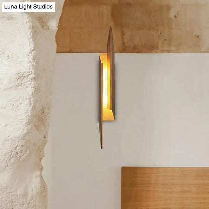 Modern brown geometric metal shade wall sconce with sleek angular design and warm amber light for living room direct wired electric