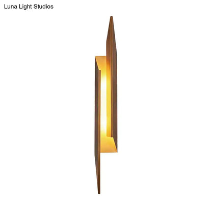 Modern brown geometric metal shade wall sconce with warm amber glow and sleek direct wired electric frame for living room light