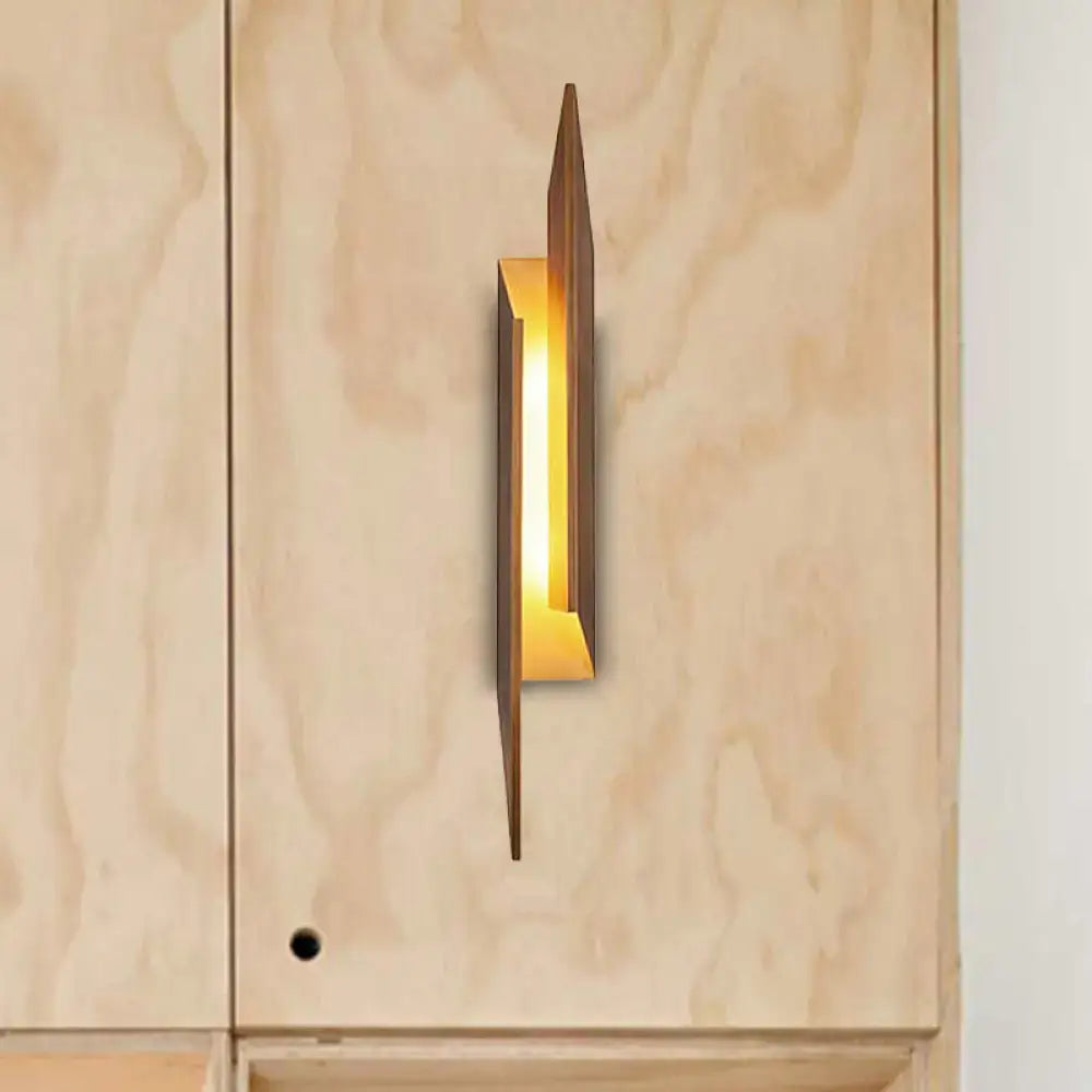 Modern brown geometric metal shade wall sconce with warm golden glow crafted from metal and wood for living room light