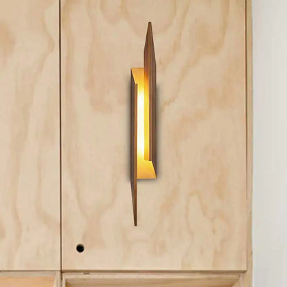 Modern brown geometric metal shade wall sconce with warm golden glow crafted from metal and wood for living room light