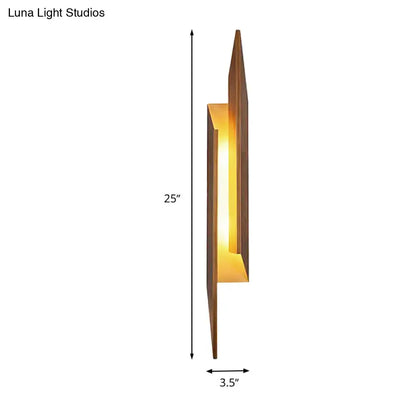Modern brown geometric metal shade wall sconce with warm amber glow crafted from dark wood and direct wired electric design