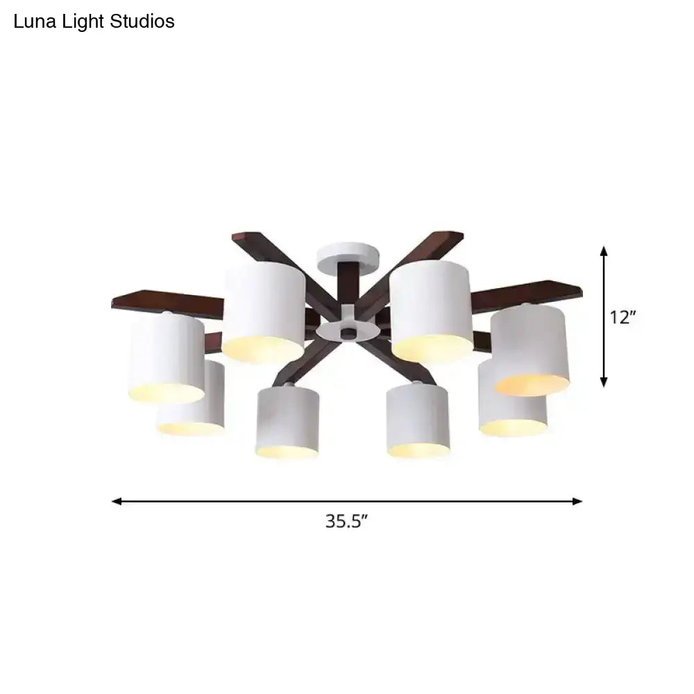 Modern brown and white ceiling mount chandelier with six cylindrical shades and dark wood arms for living room use