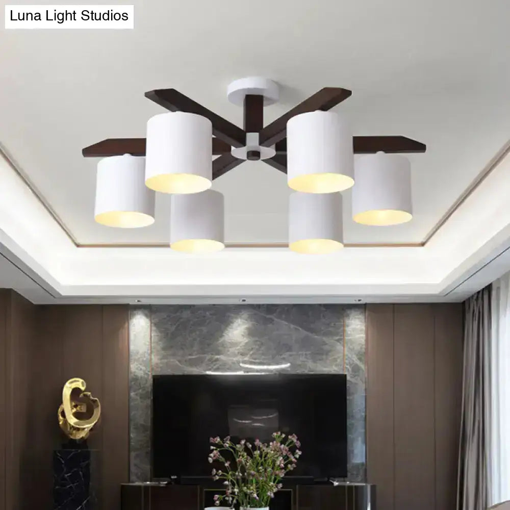 Modern brown and white ceiling mount chandelier with five white cylindrical shades and dark wood arms for living room use