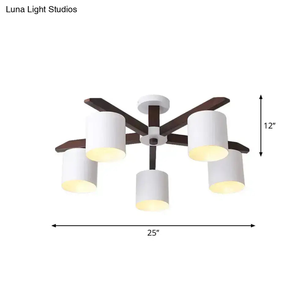 Modern brown and white ceiling mount chandelier with five cylindrical shades and dark wood arms for living room use