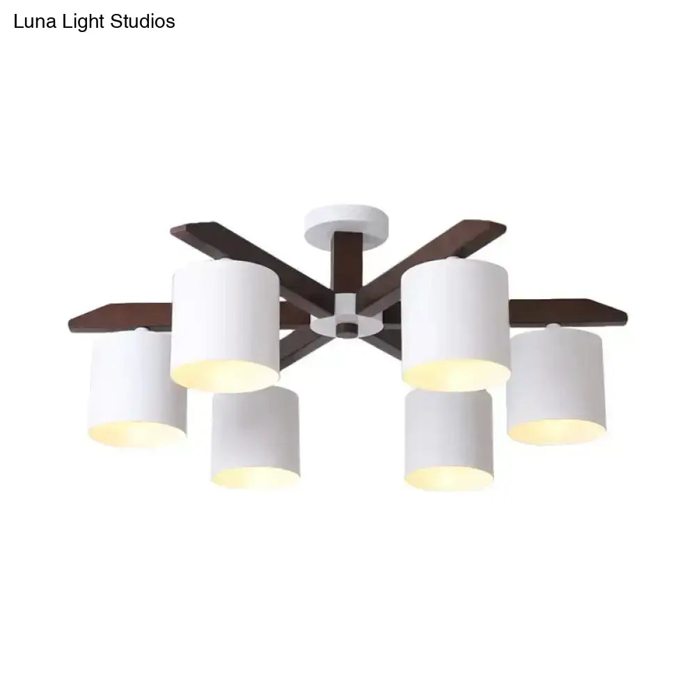 Modern brown and white ceiling mount chandelier with six white cylindrical shades and dark wood arms for living room