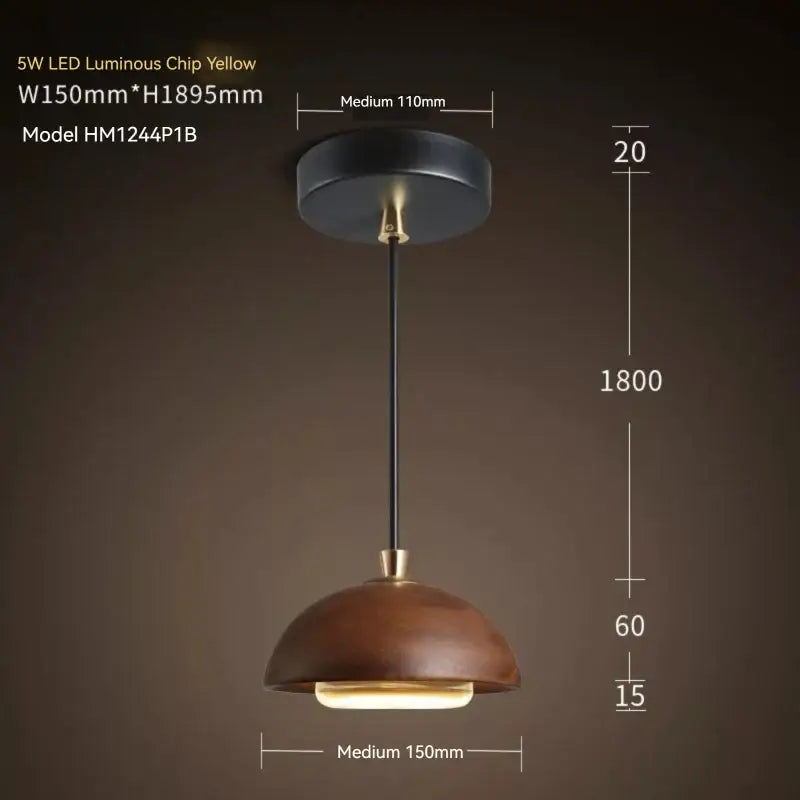A warm yellow led pendant light with a matte brown wood dome shade and black metal hardware for kitchen island