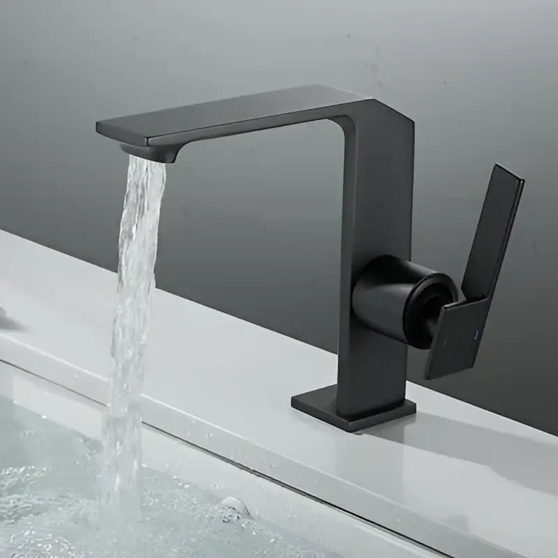Black matte basin faucet with angular design and single lever handle contrasting modern brush gold decorbites style